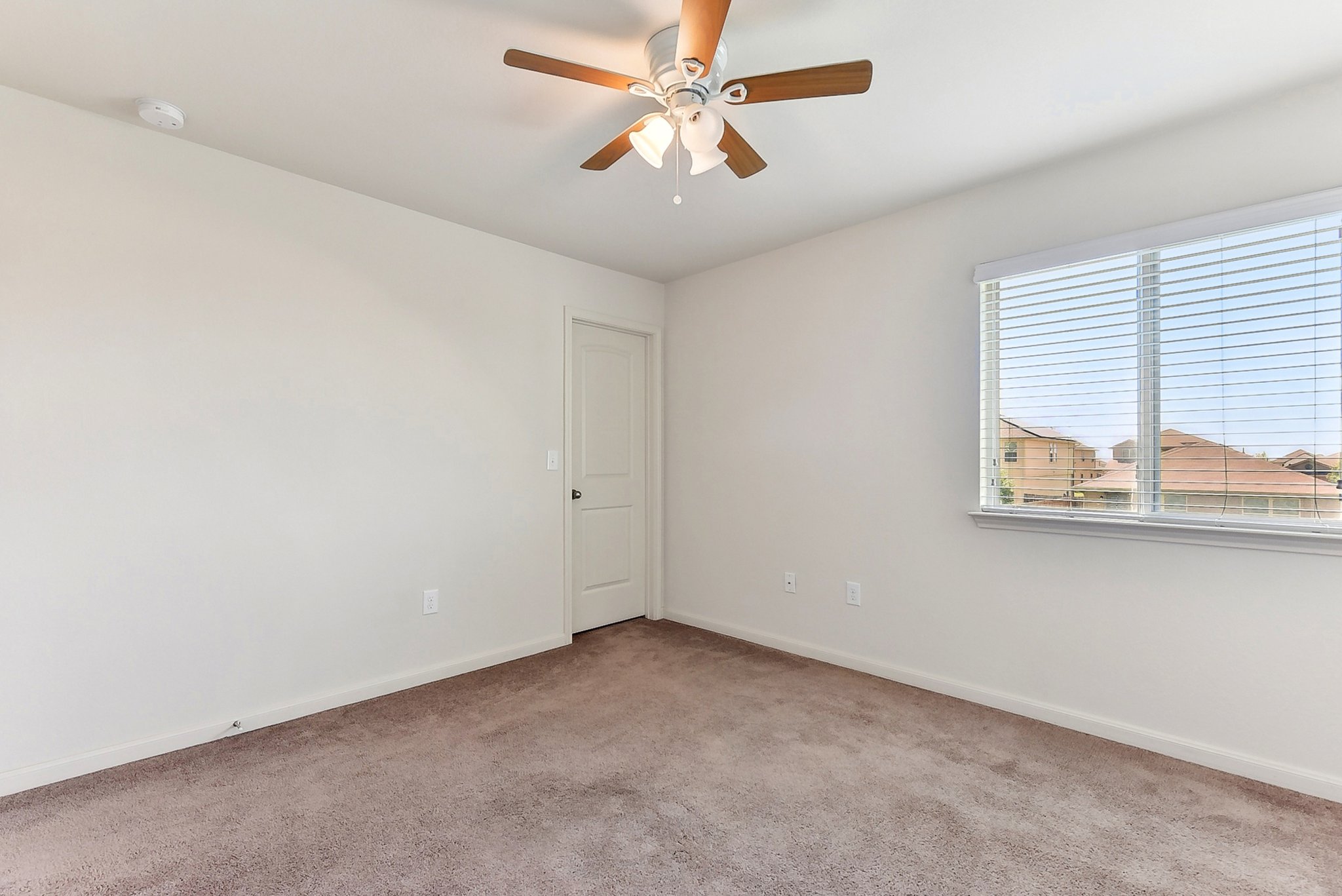 310 Potters Peak Way Georgetown, TX 78626 - Photo 14 of 21 Carpeted room featuring a ceiling fan with integrated lighting, a white paneled door, and a window with horizontal blinds