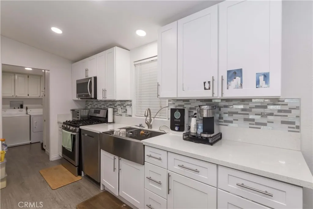 1051 Site, Unit 231 Brea, CA 92821 - Photo 11 of 34 a kitchen with white cabinets and appliances