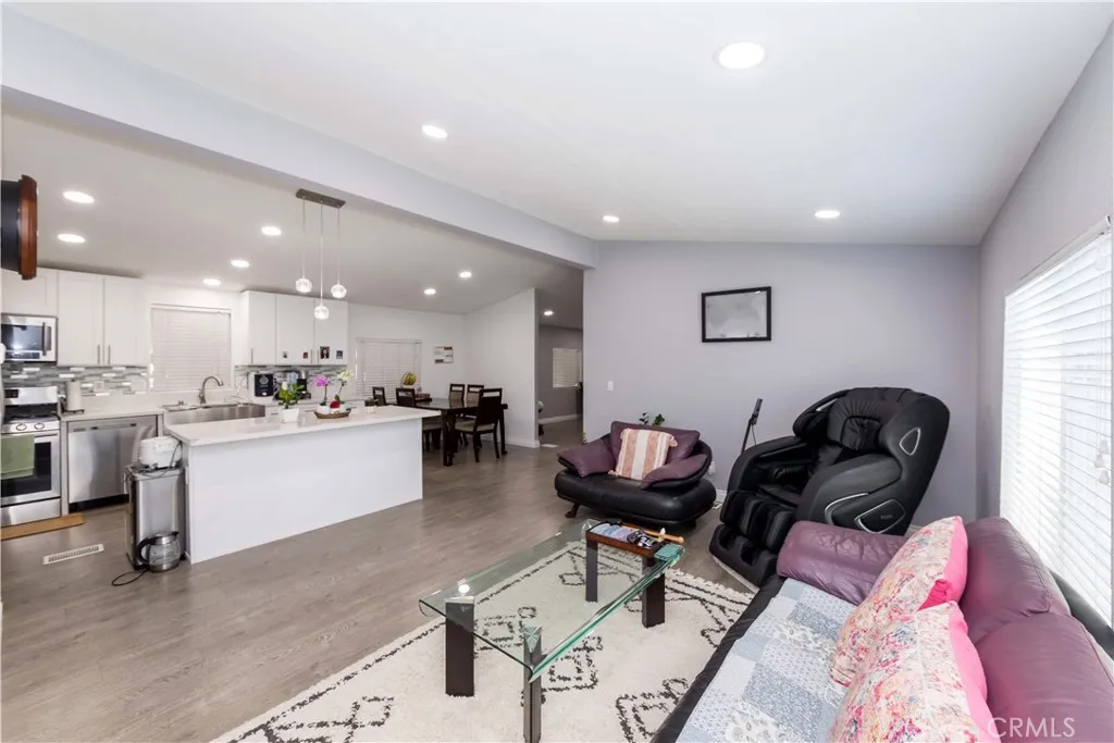 1051 Site, Unit 231 Brea, CA 92821 - Photo 15 of 34 a living room with furniture and a dining table with kitchen view