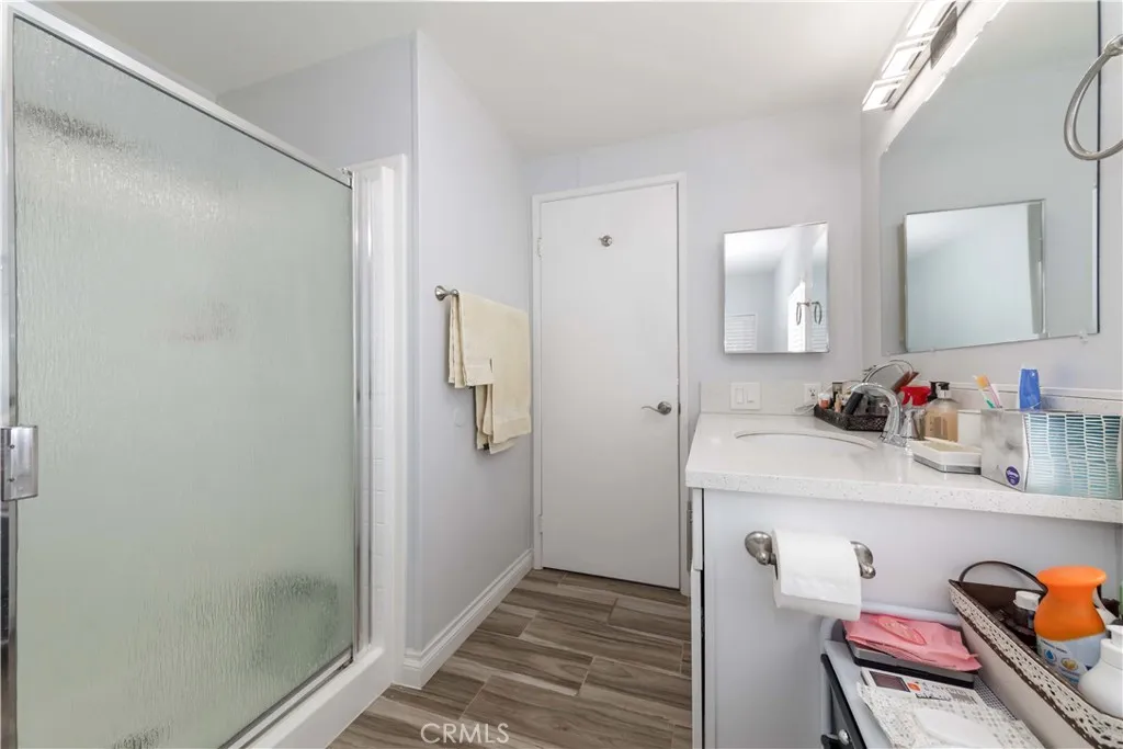 1051 Site, Unit 231 Brea, CA 92821 - Photo 22 of 34 a bathroom with a granite countertop sink and a mirror