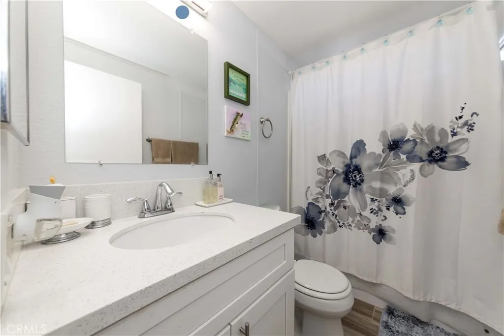 1051 Site, Unit 231 Brea, CA 92821 - Photo 34 of 34 a bathroom with a sink toilet and a mirror