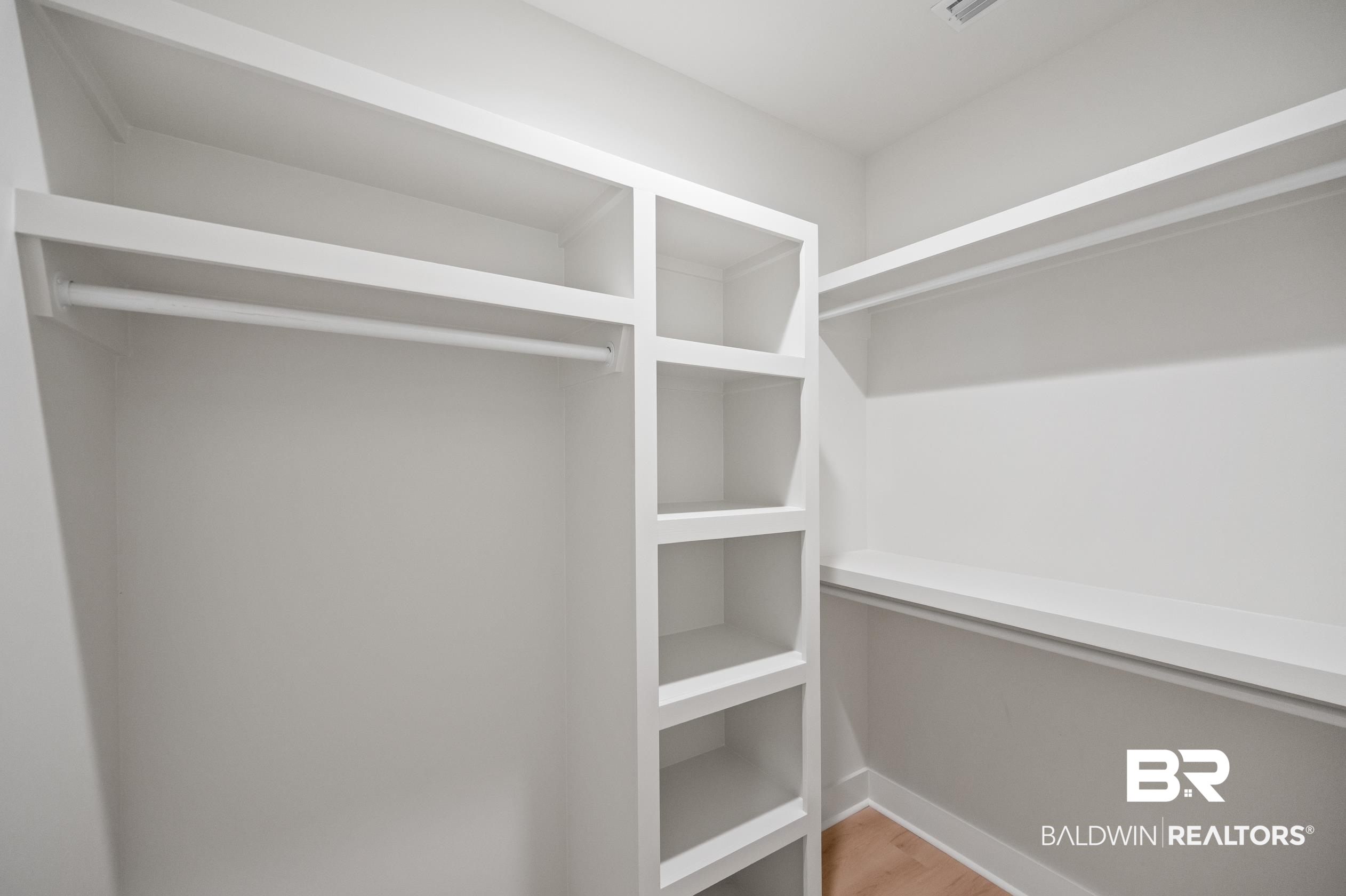 28889 Canal Road Orange Beach, AL 36561 - Photo 38 of 55 Walk in closet featuring hardwood / wood-style floors