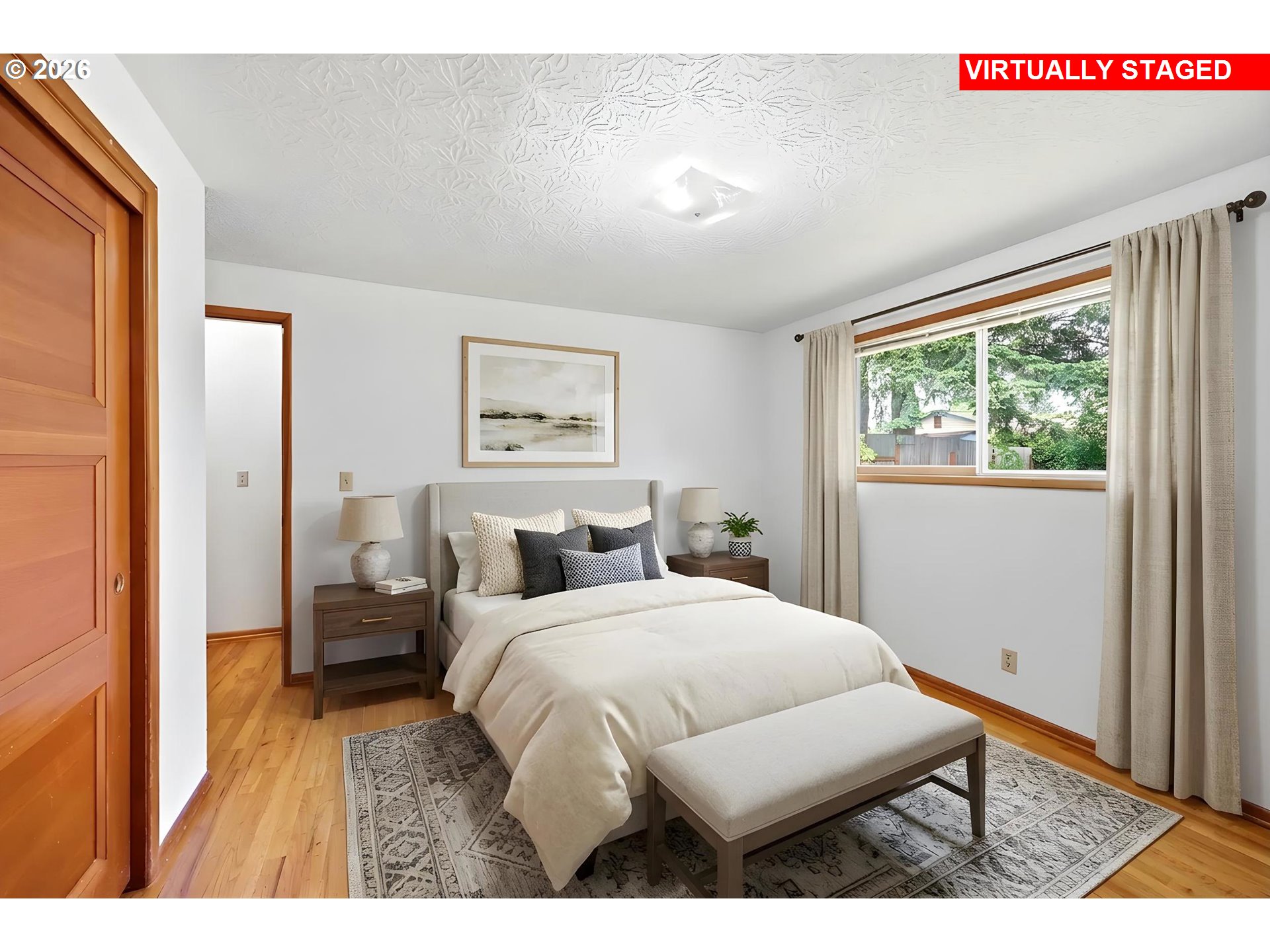 3003 Southeast 162nd Avenue Portland, OR 97236 - Photo 19 of 41 a bedroom with a bed and wooden floor