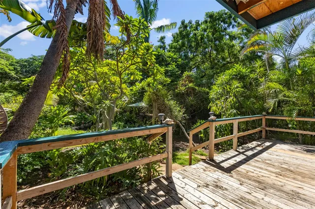 a view of a balcony with wooden floor and fence
