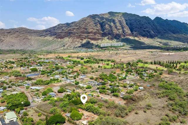 a view of a field with a mountain in the background