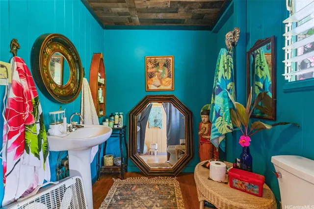 a bathroom with a sink mirror and toilet