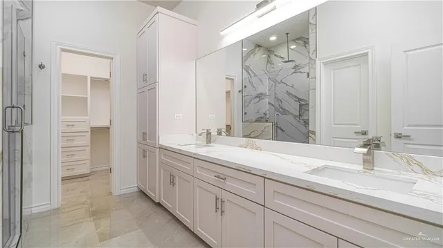 a spacious bathroom with a shower sink and mirror