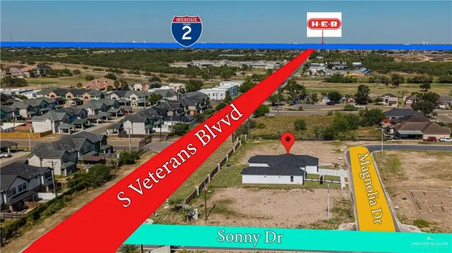 a view of a tennis ground with large trees