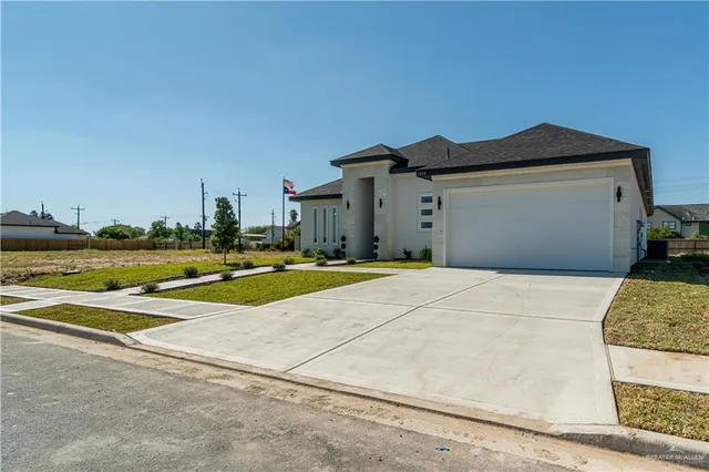 a view of an house with backyard space and a lake view
