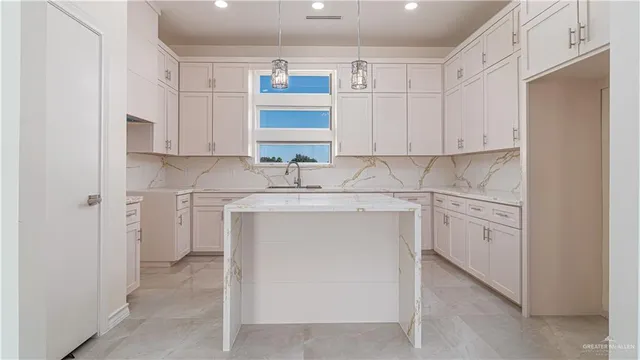 a kitchen with white cabinets and white appliances