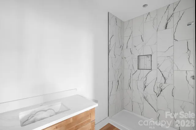 a bathroom with a bathtub and shower