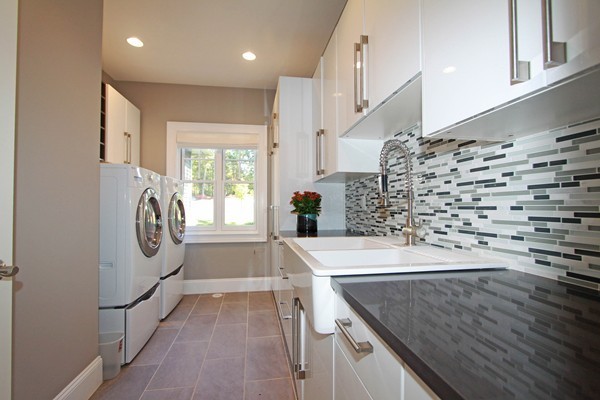 54 Monarch Path Groton, MA 01450 - Photo 18 of 29 a kitchen with a sink a stove and a wooden cabinets