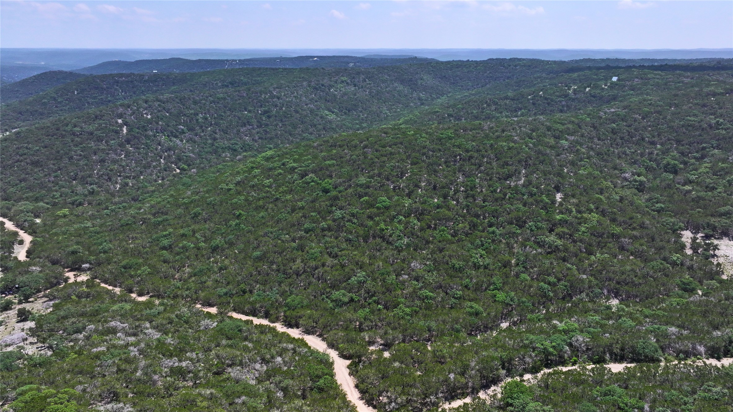 Lot 129 Spring Country Ranch Road Leakey, TX 78873 - Photo 10 of 19 a view of a lush green forest with a mountain