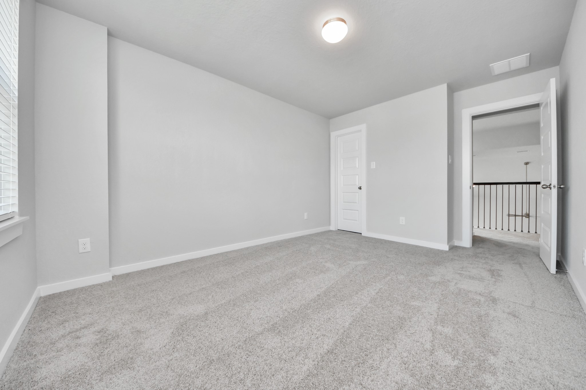 11114 Tulip Rdg Trail Houston, TX 77044 - Photo 25 of 30 Generously sized secondary bedrooms featuring spacious closets, soft and inviting carpeting underfoot, large windows allowing plenty of natural light, and the added touch of privacy blinds for your personal retreat. Sample photo of completed home with similar floor plan. Actual colors and selections may vary.