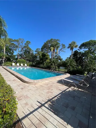 a view of a backyard with swimming pool