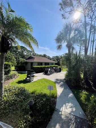 a view of a house with pool and sitting area