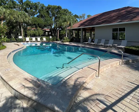 a view of a house with swimming pool and sitting area