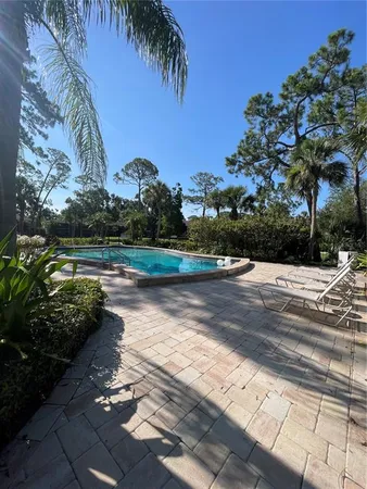 a view of a swimming pool and lounge chair