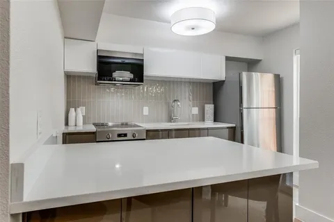 a kitchen with stainless steel appliances a sink a stove and refrigerator