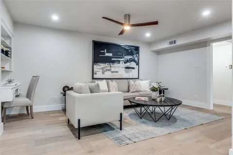 a living room with furniture and a large window with rug