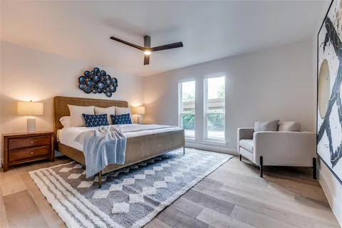 a bedroom with a bed and a large window