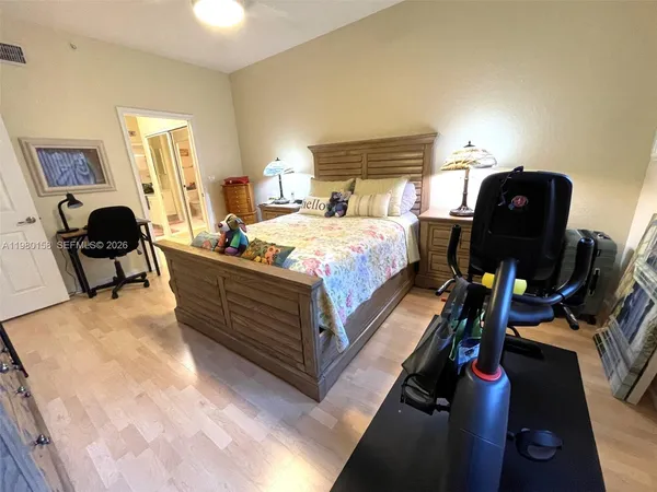 a bedroom with bed and a chair