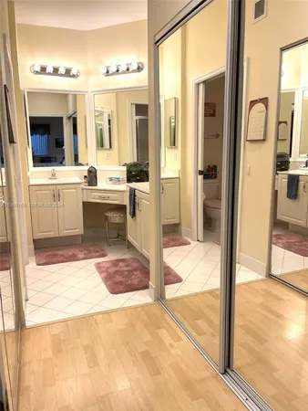 a view of a bathroom with a tub mirror and shower
