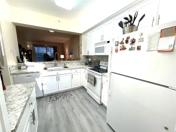 a kitchen with a sink a refrigerator and a stove