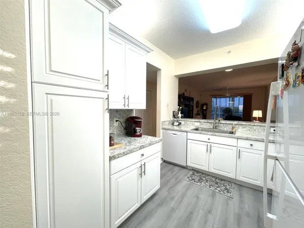 a kitchen with a sink stove and refrigerator