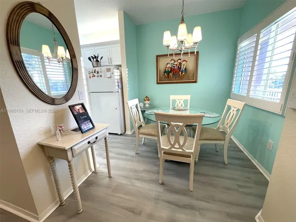 a dining room with furniture a mirror and a window