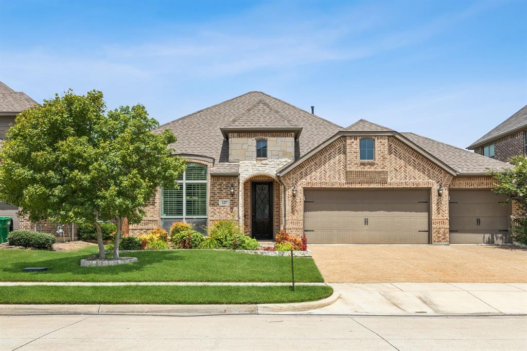 127 Stevenson Drive Fate, TX 75087 - Photo 1 of 1 a front view of a house with a garden