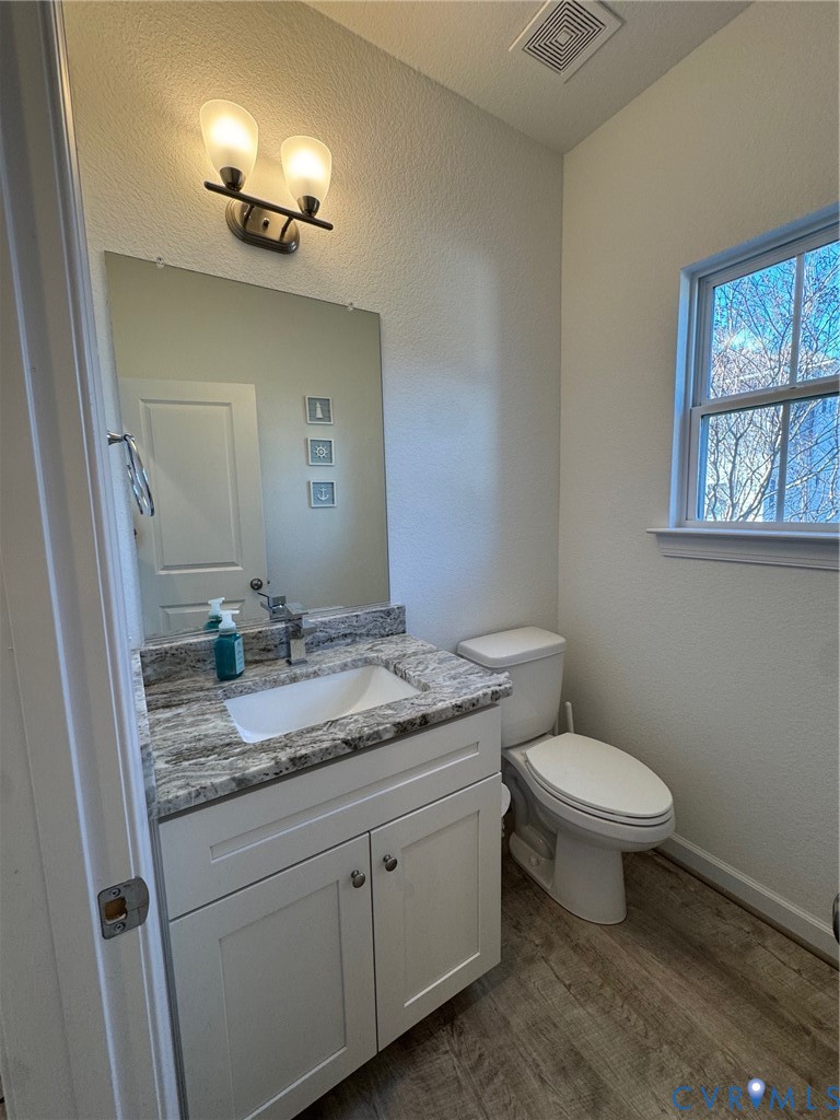 4321 Pinter Lane Norfolk, VA 23518 - Photo 13 of 19 a bathroom with a granite countertop sink a toilet and a mirror