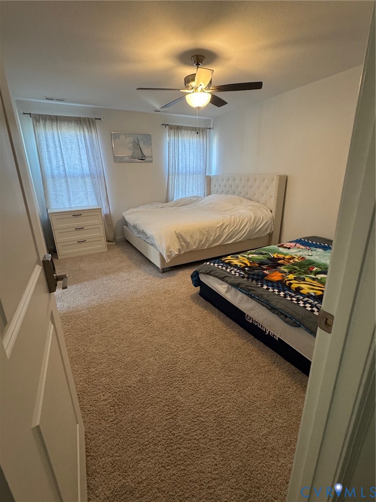 4321 Pinter Lane Norfolk, VA 23518 - Photo 14 of 19 a bedroom with a bed and a dresser next to a window