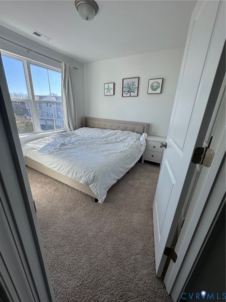 4321 Pinter Lane Norfolk, VA 23518 - Photo 17 of 19 a bedroom with a bed and a large window