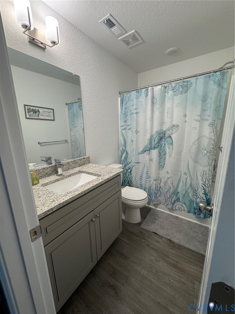 4321 Pinter Lane Norfolk, VA 23518 - Photo 19 of 19 a bathroom with a granite countertop sink a toilet a mirror and shower