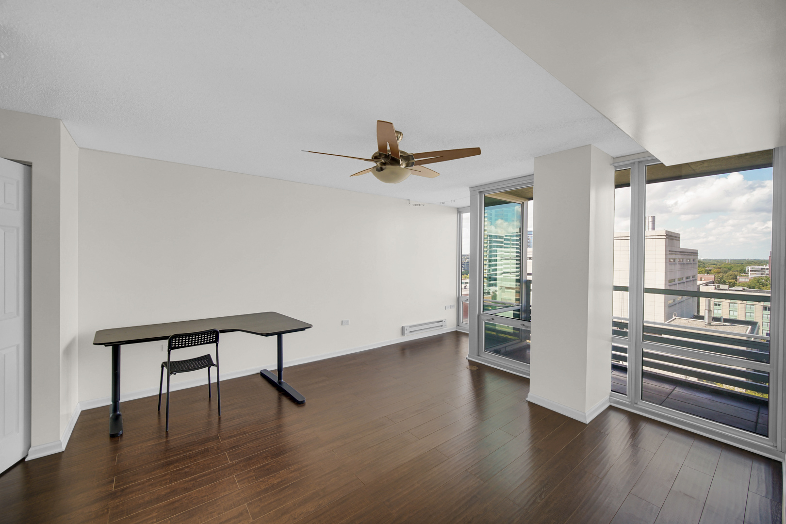 800 Elgin Road, Unit 1210 Evanston, IL 60201 - Photo 14 of 20 a view of a livingroom with wooden floor and a ceiling fan