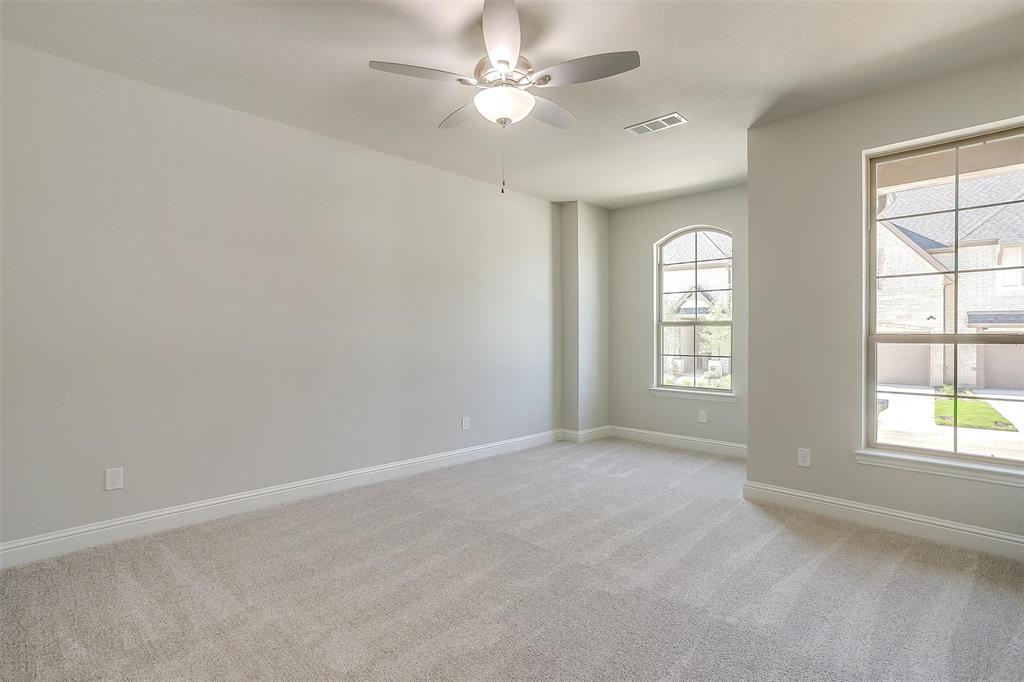 6811 Robert Reed Drive Arlington, TX 76001 - Photo 16 of 34 an empty room with windows and ceiling fan