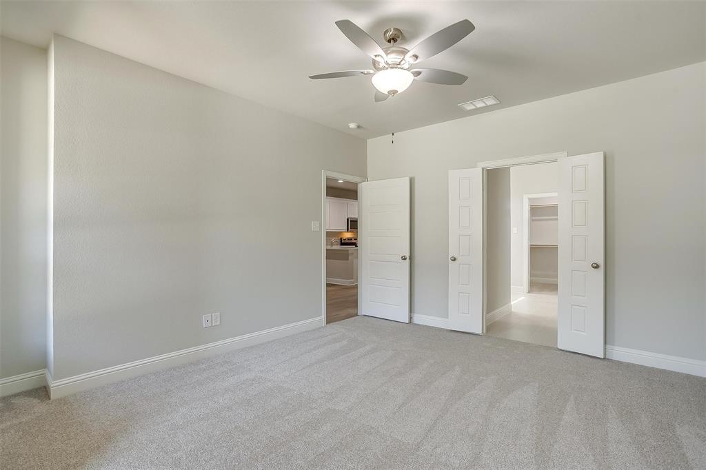 6811 Robert Reed Drive Arlington, TX 76001 - Photo 18 of 34 an empty room with closet and a ceiling fan