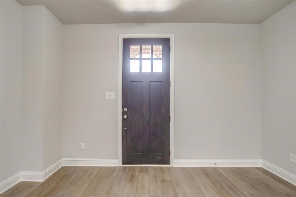 6811 Robert Reed Drive Arlington, TX 76001 - Photo 2 of 34 a view of an empty room and wooden floor