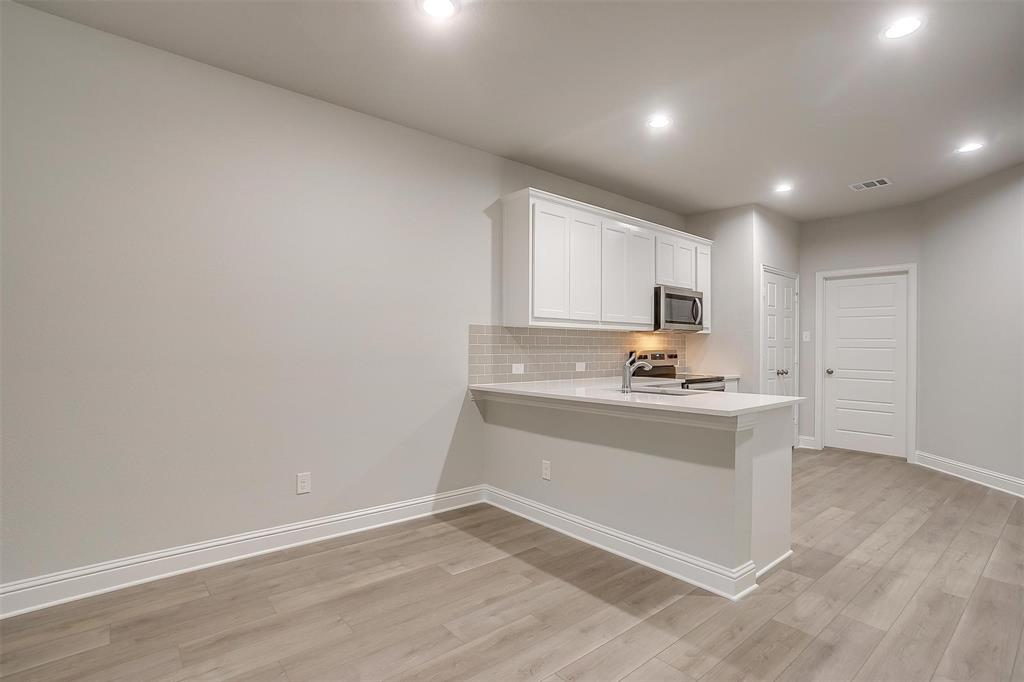 6811 Robert Reed Drive Arlington, TX 76001 - Photo 7 of 34 a view of kitchen with granite countertop cabinets and sink