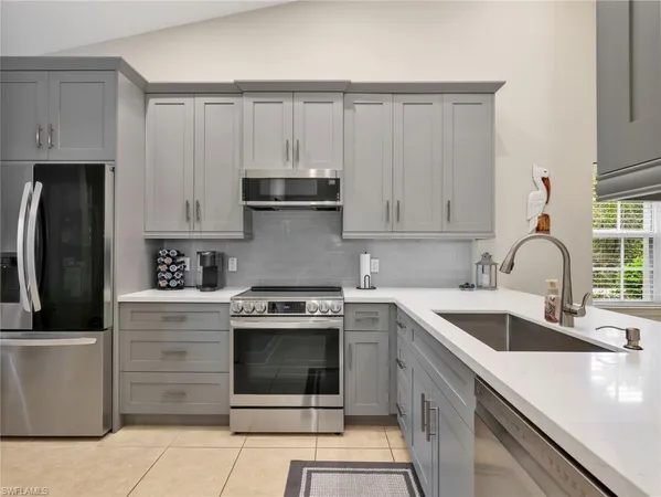 a kitchen with a stove sink and refrigerator