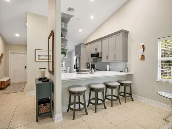 a kitchen with stainless steel appliances kitchen island granite countertop a sink and cabinets