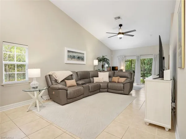 a living room with furniture and a large window