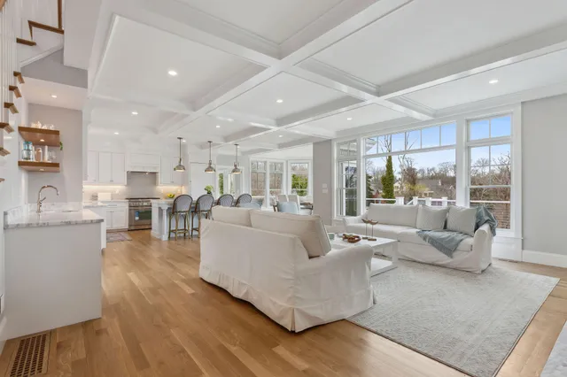 a view of a room with wooden floor and windows