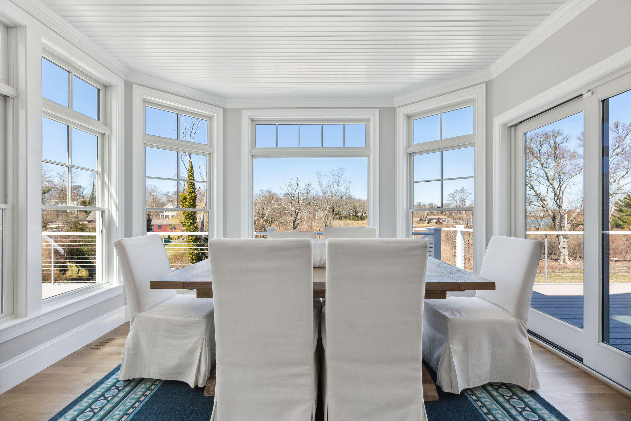 44 Tonset Road Orleans, MA 02653 - Photo 28 of 79 a dining room with furniture a rug and wooden floor
