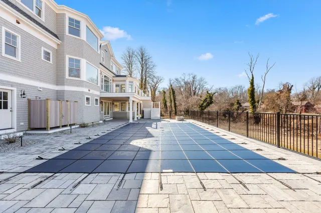 a view of a dining room with furniture large windows and wooden floor