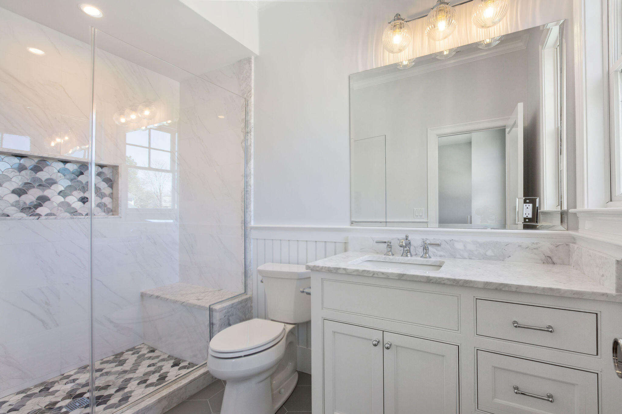 44 Tonset Road Orleans, MA 02653 - Photo 56 of 79 a bathroom with a granite countertop sink a toilet and a mirror