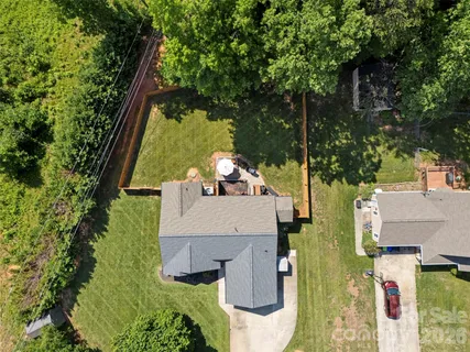 an aerial view of a house with a yard