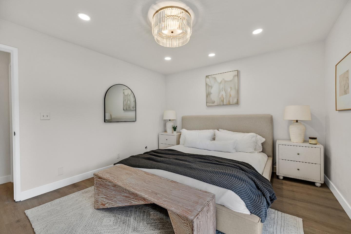 205 Red Oak Drive, Unit M Sunnyvale, CA 94086 - Photo 19 of 32 a bedroom with a bed and a chandelier