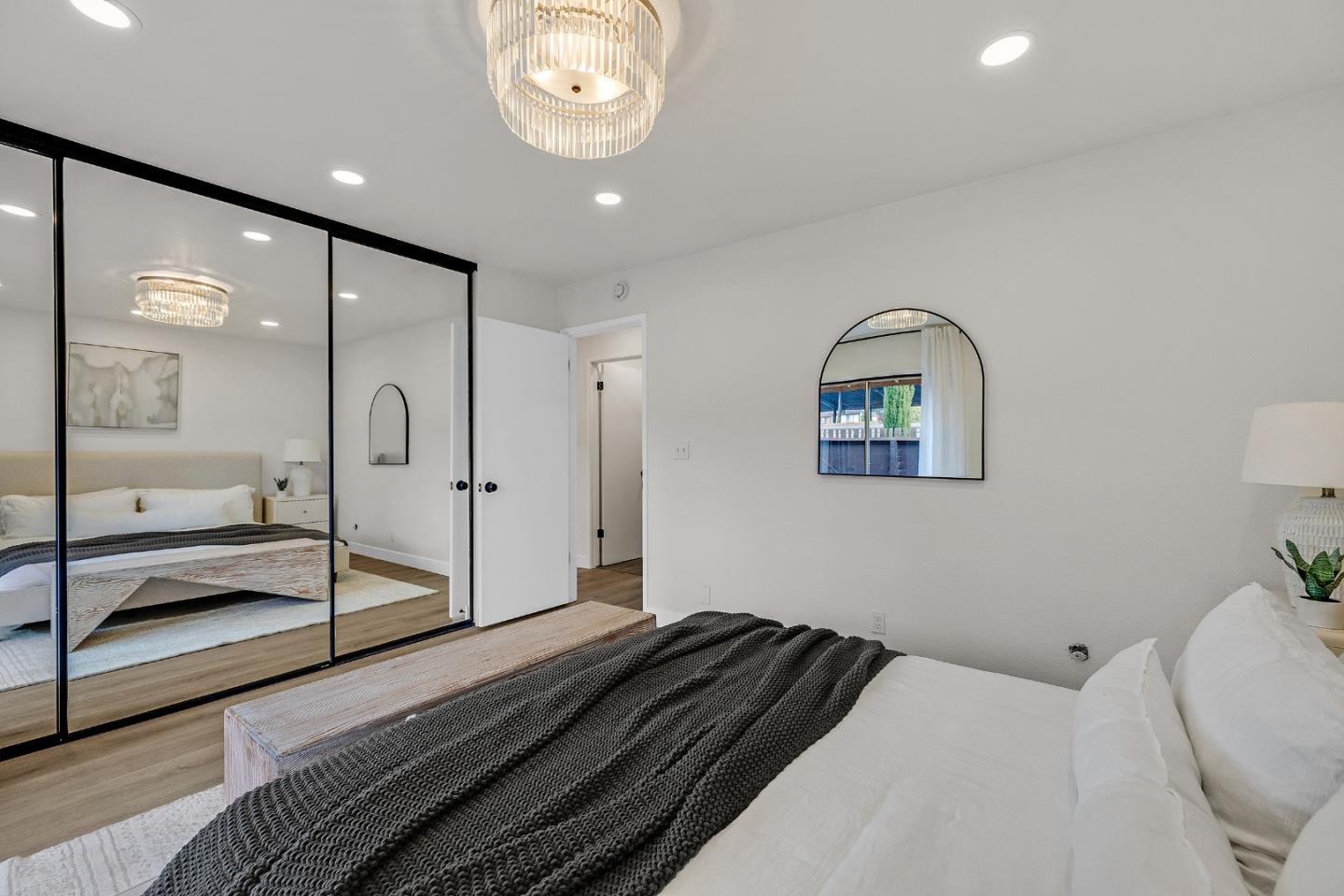 205 Red Oak Drive, Unit M Sunnyvale, CA 94086 - Photo 20 of 32 a bedroom with a bed and a chandelier